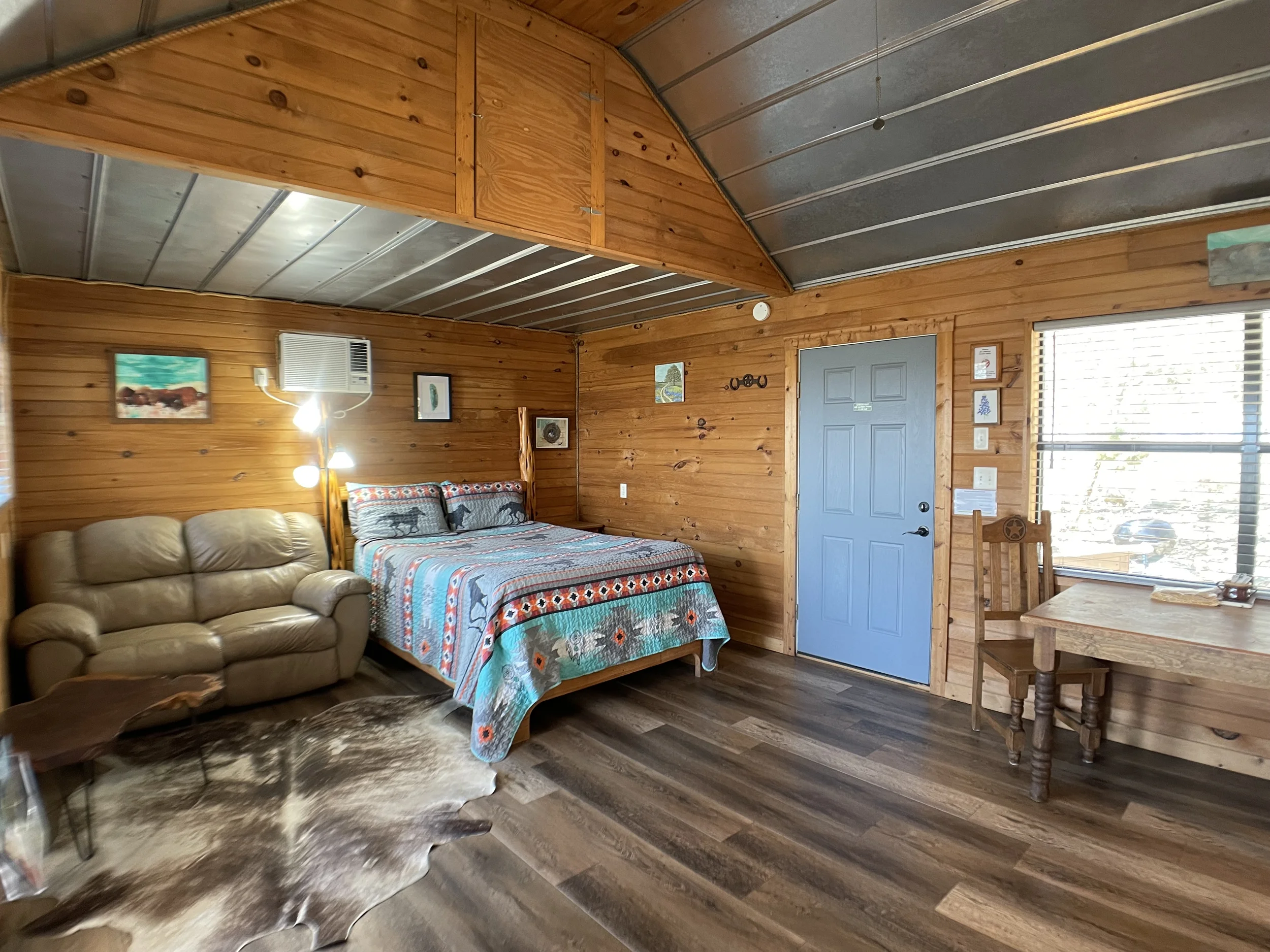 The comfortable bed and front Door from inside the Woods Cabin
